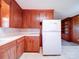 Kitchen with wood cabinets and white appliances at 112 W Highway 218 Rd, Monroe, NC 28110