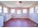 Spacious laundry room with multiple windows and red tile floor at 112 W Highway 218 Rd, Monroe, NC 28110