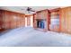 Living room with brick fireplace and wood paneling at 112 W Highway 218 Rd, Monroe, NC 28110