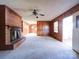Spacious living room with wood paneling and fireplace at 112 W Highway 218 Rd, Monroe, NC 28110
