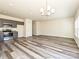 Open living room with wood-look flooring and access to the kitchen at 508 Kingsway Cir, Charlotte, NC 28214