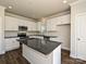 Modern kitchen with white cabinets, dark countertops, and stainless steel appliances at 512 Kingsway Cir, Charlotte, NC 28214