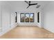 Light-filled bedroom with hardwood floors and large windows at 19413 Coachmans Trce, Cornelius, NC 28031