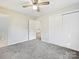 Bright bedroom with grey carpet, double closets, and access to bathroom at 111 Bobby Lee Ln # 18, Mooresville, NC 28115