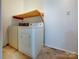 Laundry area with washer, dryer, and overhead shelving at 111 Bobby Lee Ln # 18, Mooresville, NC 28115