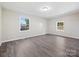Bedroom with gray vinyl flooring and a view of the backyard at 111 Bobby Lee Ln # 18, Mooresville, NC 28115