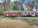 Brick ranch home with red shutters, landscaping, and a spacious lawn at 111 Bobby Lee Ln # 18, Mooresville, NC 28115