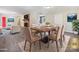 Bright dining area with hardwood table and chairs, situated near the living room at 111 Bobby Lee Ln # 18, Mooresville, NC 28115
