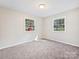 Well-lit bedroom with two windows and grey carpet at 111 Bobby Lee Ln # 18, Mooresville, NC 28115
