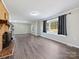 Spacious living room with fireplace, large windows, and vinyl flooring at 111 Bobby Lee Ln # 18, Mooresville, NC 28115