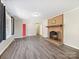 Open living room with a brick fireplace and gray vinyl plank flooring at 111 Bobby Lee Ln # 18, Mooresville, NC 28115