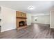 Living room with brick fireplace and gray vinyl flooring at 111 Bobby Lee Ln # 18, Mooresville, NC 28115