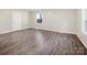 Simple bedroom with gray vinyl flooring and two windows at 111 Bobby Lee Ln # 18, Mooresville, NC 28115
