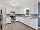 View of the kitchen with white cabinets and granite countertops at 111 Bobby Lee Ln # 18, Mooresville, NC 28115