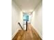 Light-filled upper hallway with wood floors and staircase leading to the lower level at 3860 Nc Hwy 200 Hwy, Concord, NC 28025
