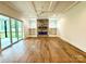 Gathering room with stone fireplace, built-in shelving, and hardwood floors at 3860 Nc Hwy 200 Hwy, Concord, NC 28025
