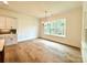Bright dining room features hardwood floors and large windows with wooded views at 3860 Nc Hwy 200 Hwy, Concord, NC 28025