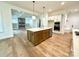 Open concept kitchen with island, stainless steel appliances and view into living room at 3860 Nc Hwy 200 Hwy, Concord, NC 28025
