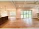Spacious Gathering room features hardwood floors, sliding doors to patio, and coffered ceiling at 3860 Nc Hwy 200 Hwy, Concord, NC 28025