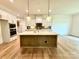 Island kitchen with stainless steel appliances and hardwood floors at 3860 Nc Hwy 200 Hwy, Concord, NC 28025