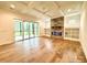 Gathering room with stone fireplace, built-in shelving, and hardwood floors at 3860 Nc Hwy 200 Hwy, Concord, NC 28025