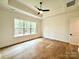 Spacious bedroom with hardwood floors and large window at 3860 Nc Hwy 200 Hwy, Concord, NC 28025