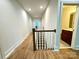 Upstairs hallway with hardwood floors and view of bathroom at 3860 Nc Hwy 200 Hwy, Concord, NC 28025