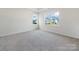 Spacious bedroom with gray carpet and large windows at 8915 Nettleton Ave, Charlotte, NC 28215