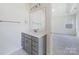 Bathroom with gray vanity, white countertop, and marble flooring at 8915 Nettleton Ave, Charlotte, NC 28215