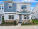 Two-story townhome with gray siding and stone accents at 8915 Nettleton Ave, Charlotte, NC 28215