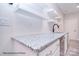 Basement bar with granite countertop, white cabinets, and floating shelves at 106 Windbluff Ct # 163, Statesville, NC 28677