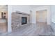 Stone fireplace with a rustic mantel in a light-filled room at 106 Windbluff Ct # 163, Statesville, NC 28677