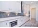 Modern kitchen featuring white cabinets, stainless steel appliances, and geometric backsplash at 106 Windbluff Ct # 163, Statesville, NC 28677