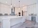 Spacious kitchen with white cabinets, large island, and high-end appliances at 106 Windbluff Ct # 163, Statesville, NC 28677