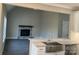 Kitchen island with farmhouse sink overlooks a living room with a stone fireplace at 156 Clear Springs Rd, Mooresville, NC 28115