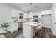 Modern white kitchen with stainless steel appliances and breakfast bar at 108 1St St, Huntersville, NC 28078