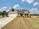 Newly built brick home with a spacious front yard and driveway at 1005 Piper Meadows Dr # 1, Waxhaw, NC 28173