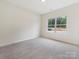 Bright bedroom with large window and neutral carpeting at 1005 Piper Meadows Dr # 1, Waxhaw, NC 28173