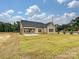 New construction home exterior with brick accents and a covered patio at 1005 Piper Meadows Dr # 1, Waxhaw, NC 28173