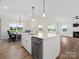 Modern kitchen with white cabinets, large island, and stainless steel appliances at 1005 Piper Meadows Dr # 1, Waxhaw, NC 28173