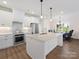 Modern kitchen with white cabinets, large island, and stainless steel appliances at 1005 Piper Meadows Dr # 1, Waxhaw, NC 28173