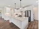 Modern kitchen with white cabinets, large island, and stainless steel appliances at 1005 Piper Meadows Dr # 1, Waxhaw, NC 28173