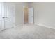 Well-lit bedroom with double doors and carpet flooring at 113 Ryan Ln, Mooresville, NC 28115