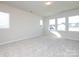 Spacious bedroom featuring neutral walls, carpet flooring, and multiple windows at 113 Ryan Ln, Mooresville, NC 28115