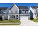 Two-story home with gray and blue siding, white garage door, and landscaping at 113 Ryan Ln, Mooresville, NC 28115