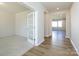 Bright hallway with hardwood floors, French doors, and carpeted room at 113 Ryan Ln, Mooresville, NC 28115