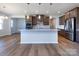 Modern kitchen with island, hardwood floors and stainless steel appliances at 113 Ryan Ln, Mooresville, NC 28115