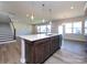 Modern kitchen with island, hardwood floors and stainless steel appliances at 113 Ryan Ln, Mooresville, NC 28115
