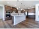 Modern kitchen with island, hardwood floors and stainless steel appliances at 113 Ryan Ln, Mooresville, NC 28115
