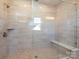 Large walk-in shower with neutral tile and built-in seat at 113 Ryan Ln, Mooresville, NC 28115